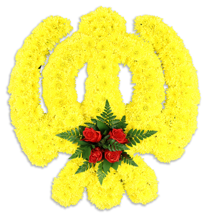 This image shows a large floral Khanda composed of countless bright yellow chrysanthemum heads, each bloom tightly arranged to map the emblem's distinctive chakkar, central khanda blade and the two crossed kirpans in plush, tactile form. The yellow mass has a subtle sculptural relief; light grazes the ruffled petals and creates a soft sheen that enhances the piece's three-dimensional presence against a plain white studio background. Anchoring the design is an elegant cluster of five deep red roses at the centre where the circular element meets the sword - their rich colour and velvety texture giving a solemn, intimate accent. Surrounding the roses, deep green fern foliage fans outward, providing contrast in colour and a delicate, feathery texture that frames the red like a botanical halo. A gentle grey shadow beneath the tribute indicates it is a substantial, freestanding display, suited to memorial services, gurdwara ceremonies, or cultural celebrations that honour Sikh tradition. The arrangement reads as both artisanal and respectful; it speaks of careful handwork, bloom selection and the quiet intent of floral design. Locally, this kind of piece would be recognised and appreciated at events around Lower Clapton - from Chatsworth Road gatherings to moments of remembrance near Clapton Pond - where its symbolism and colour palette convey dignity, solace, and communal respect.