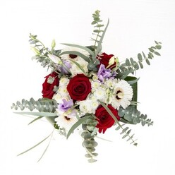 From the perspective of a Lower Clapton florist, this bouquet embodies the area's creative yet harmonious spirit. Spiraled, velvety red roses sit at the centerpiece-a timeless symbol of affection-while luminous white gerberas with espresso-toned centers anchor the arrangement with a steady, elegant presence. Wispy eucalyptus floats above, introducing motion and a subtle, invigorating scent that brings to mind the fresh air along the River Lea. Lilac lisianthus, some in delicate bud, pepper the composition with contemporary flair, much like the vibrant palette you might see on a stroll past the local Sunday market. Clouds of white filler flowers impart plush softness, giving the bouquet a luxurious feel, while broad, glossy leaves wrapped artfully around the base finish the piece with crowd-pleasing polish. Every fresh green stem is displayed clearly within its vase, affirming the bouquet's quality and freshness. This inviting arrangement easily suits a range of occasions-anniversaries, new beginnings, or simply showing gratitude within the Lower Clapton community-while offering a tangible sense of local craftsmanship and artistry.
